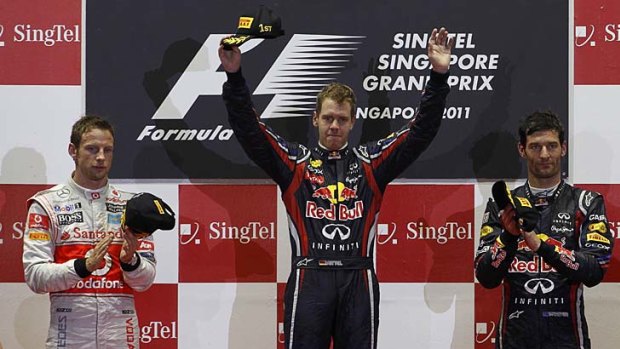 Winner Sebastian Vettel of Germany is flanked by second-placed Jenson Button (left) of Britain and third-placed Mark Webber of Australia.