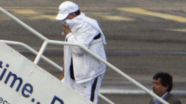 Lockerbie bomber Abdel Baset al-Megrahi, left, walks on to his airplane at Glasgow International Airport.