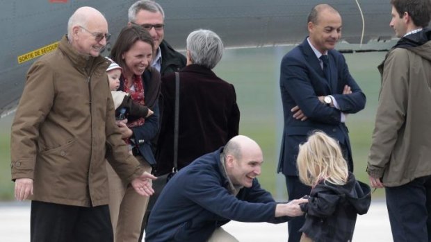 Nicolas Henin, centre, meeting his daughter upon his arrival in France. The French journalist was held with murdered US journalist James Foley. 