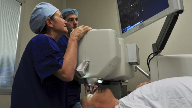 Eye surgeon Dr Kerrie Meades, left, and technician Olivier Fourcot, with a patient.