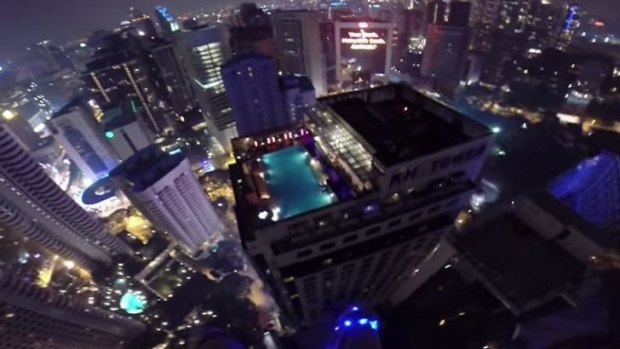 A screengrab of Van Horne's BASE jump into a rooftop pool in Kuala Lumpur. 