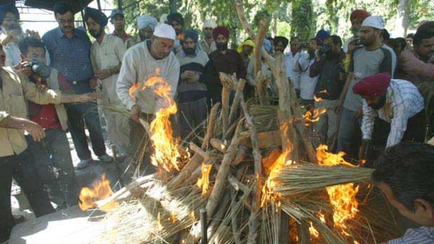 Scenes of grief ... Gurshan Singh Channa is cremated.