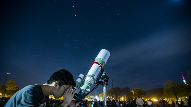 Belconnen's Blasius Kim, 18, spotted Saturn as onlookers gathered to break a stargazing world record.


 21 August 2015
Photo: Rohan Thomson
The Canberra Times