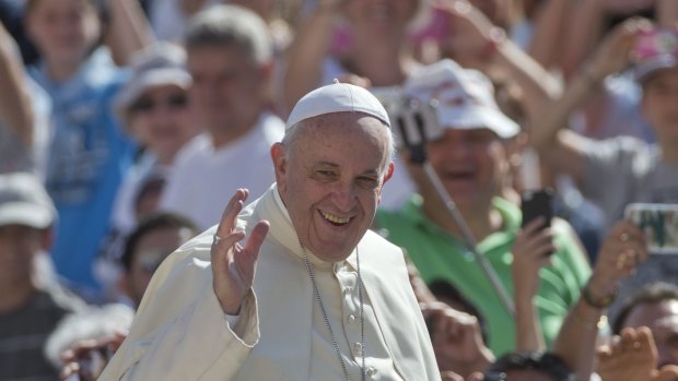 Invitation to reconciliation ... Pope Francis waves as arrives for his weekly general audience in St Peter's Square at the Vatican on August 26. 