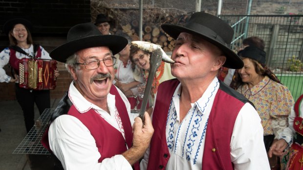 Acacio Antunes (left) and Sam Alfonso get an early taste of the Festival Da Sardinha.