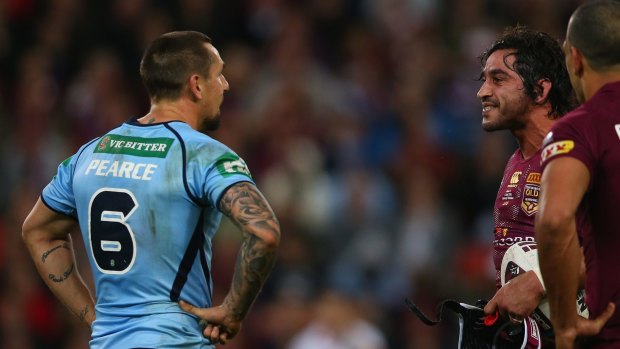 Mitch cops it back: Mitchell Pearce and Johnathan Thurston exchange words.