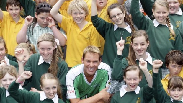 Star value: Shane Warne poses with St Josephs Primary School students.