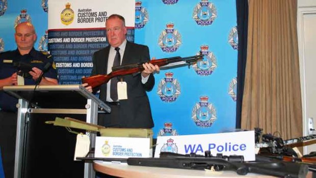 Detective inspector Dale Davies displays some of the seized weapons.