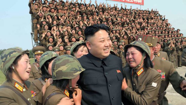 North Korean leader Kim Jong-Un smiling with female soldiers.