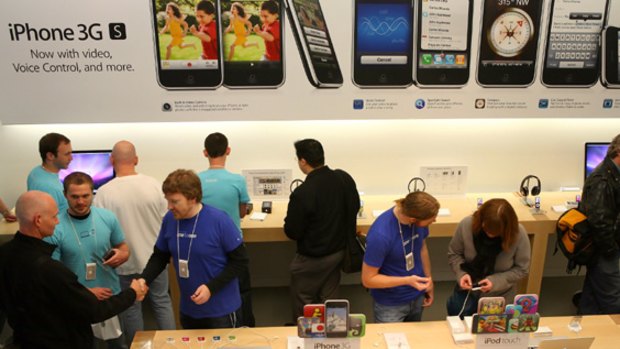 Apple Store customers check out the new iPhone 3GS.