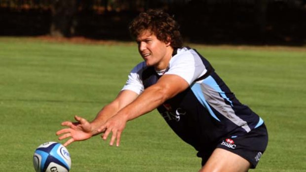 Tuning up ... Waratahs halfback Luke Burgess, training at Moore Park yesterday, says the home side is ‘‘looking to express ourselves, not hold back or be reserved’’ against the Reds.
