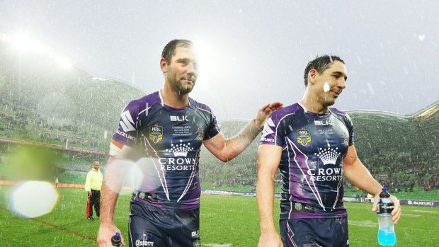 A stormy night indeed as Cameron Smith and Billy Slater walk off AAMI Park in the driving rain after the win over Penrith.