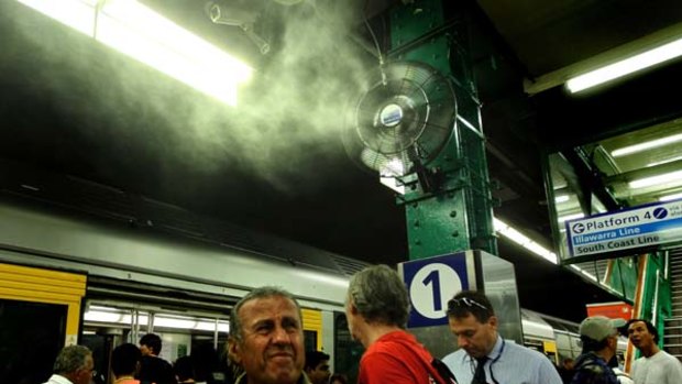 Commuters at Town Hall station attempt to stay cool.