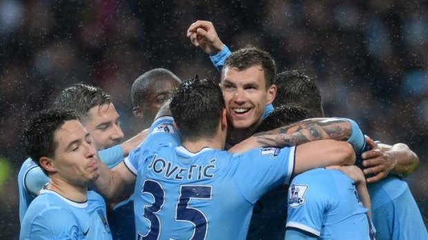 Singing, the Blues: Edin Dzeko and his Manchester City teammates celebrate the victory over Aston Villa on Wednesday that all but sealed the Premier League title.