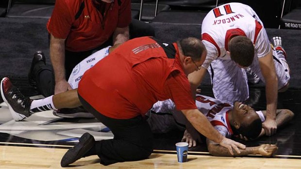 Horror injury ... Kevin Ware is comforted by a teammate after breaking his leg.