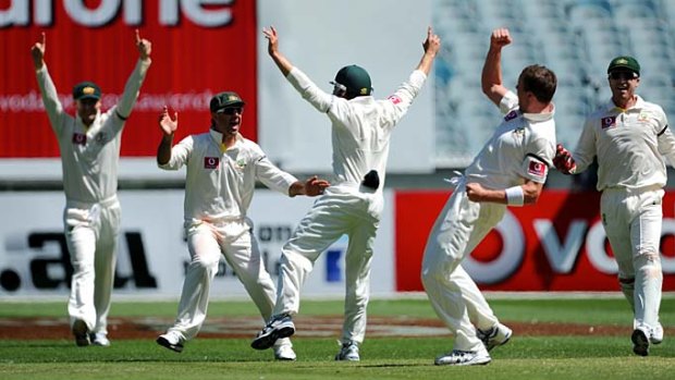 Moment of triumph: the Australians celebrate the taking of Ravichandran AshwIn's wicket by Peter Siddle at the MCG yesterday.