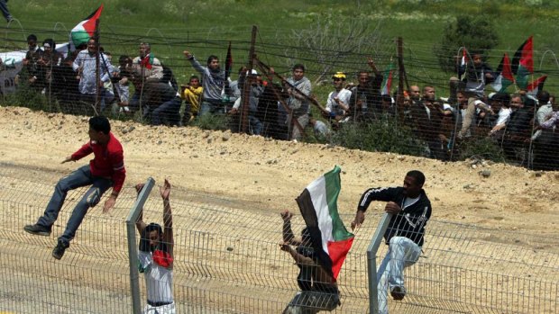 Infiltration ... Palestinian protesters at the border fence.