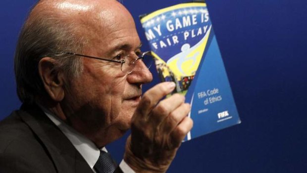 FIFA President Sepp Blatter displays the FIFA booklet 'My Game is Fair Play'.