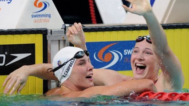 Cate Campbell (right) celebrates with her sister, Bronte, after winning the women's 100 metre freestyle event on Saturday.