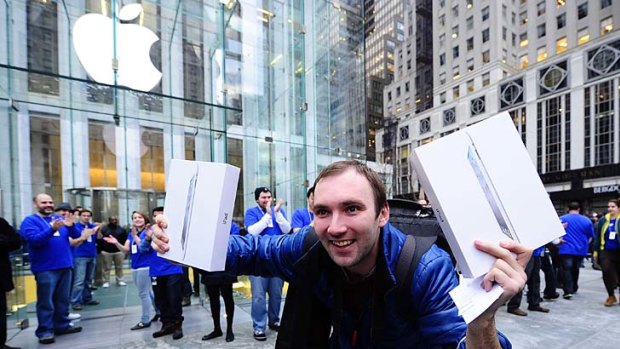 Alex Shumilov celebrates being the first customer to buy the latest Ipad 2 at the Apple store on Fifth Avenue in New York.