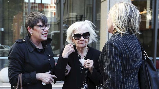 Vivienne Wighton (centre) with her two daughters, Ley, left, and Jen, right, outside the Supreme Court in Sydney.