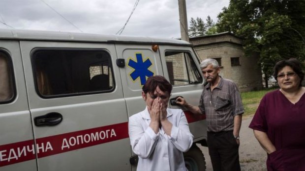 A nurse cries after seeing the bodies of killed Ukrainian army soldiers in Volnovakha.