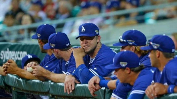 Set to return: The LA Dodgers watch from the dugout during an exhibition game at the SCG.