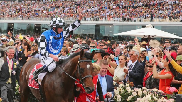 Man in demand: Ryan Moore returns to the parade ring on Protectionist after the Melbourne Cup win.