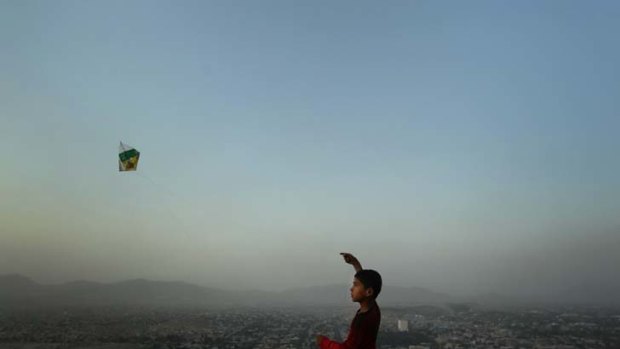 The kite flyer ... as the sun sets over Kabul, a young boy enjoys an innocent pastime. When foreign troops leave in 2014 life may be even more unpredictable.