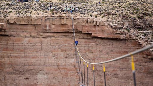 Fait accompli: Nik Wallenda braves strong winds to wire-walk across the Little Colorado River Gorge.