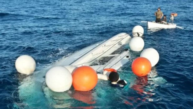 Tragedy... local fishermen look a yacht used to transport immigrants illegally that overturned in a fatal accident near the Greek island of Samos. At least 22 drowned.