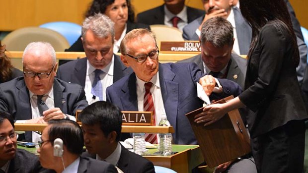 A campaign on the global hustings ... the Foreign Minister, Bob Carr, centre, places his vote in the ballot box with the Australian ambassador, Gary Quinlan, seated left.