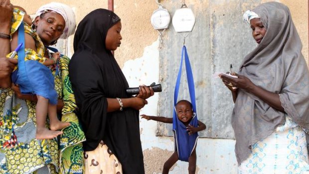 In the balance ... a child is weighed at a clinic in Maine Soroa, Niger, that screens children for malnutrition.