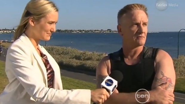 Andrew Houston is interviewed by a reporter after being attacked by a small shark at Elwood beach in October 2011.