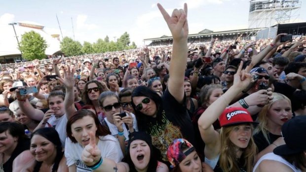 Music fans enjoy the hard rock and heavy metal bands performing at the Soundwave music festival at the Melbourne Showgrounds.