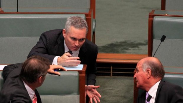 Craig Thompson talks with independents Rob Oakeshott and Tony Windsor during Christopher Pyne's attempt to force Mr Thomson to address Parliament.