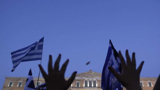 Greek citizens rally as the debt-saddled nation fights off bankruptcy.