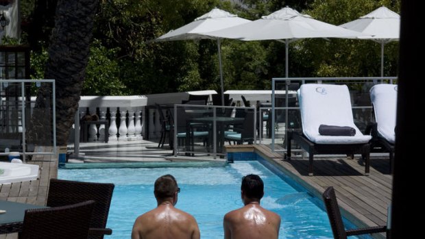 Guests sit poolside at the Glen Boutique Hotel.