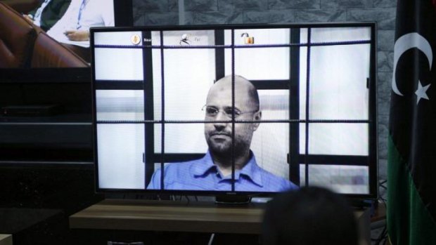 Saif al-Islam Gaddafi on a screen via video link in a Tripoli court.