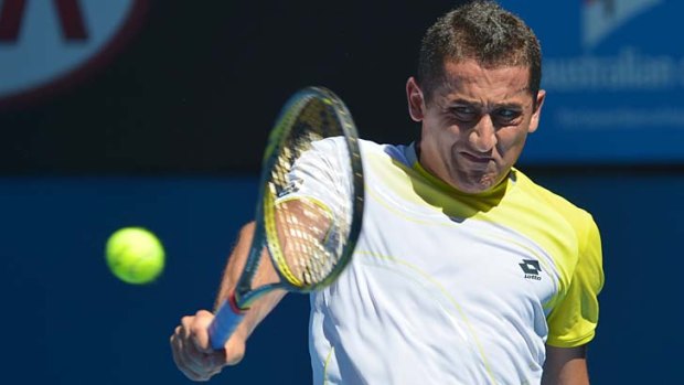 Classy: Nicolas Almagro indulges in a single-handed backhand shot against David Ferrer.