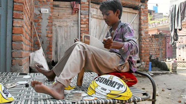 Pittance: Ramandeep, 13, earns about $1.20 a day stitching Summit balls bound for sale in Australia.