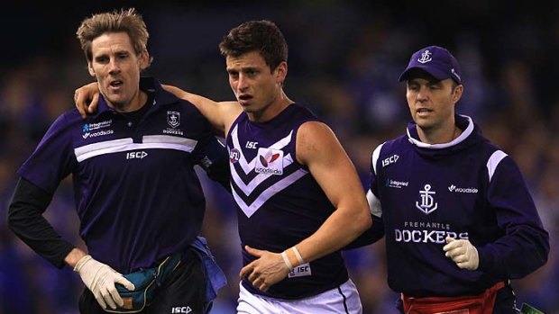 Fremantle's Alex Silvagni leaves the field injured during the game against North Melbourne,