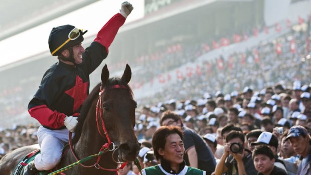 Olivier Doleuze from France celebrates after winning the Cathay Pacific Hong Kong Mile race on 'old timer' Good Ba Ba.