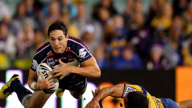 Superstar ... flying Billy Slater, in action here against Parramatta, is well on his way to joining the illustrious ranks of Australian rugby league's greatest ever, being compared to the Little Master, Clive Churchill.