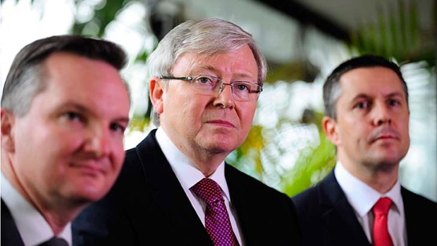 Prime Minister Kevin Rudd, pictured with Chris Bowen and Mark Butler, says the early move to an emissions trading scheme will save an average household around $380 next financial year.