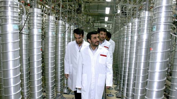 Iranian President Mahmoud Ahmadinejad, seen here at a uranium  facility in 2008, has a difficult task ahead as international sanctions take effect.