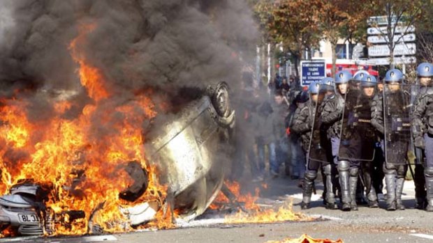 Police clashed with youths after they set a car alight in Nanterre.