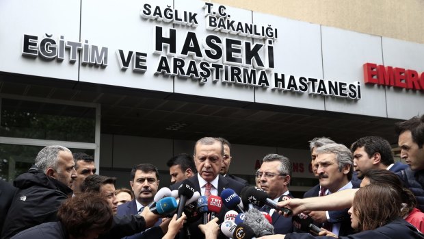 Turkish President Recep Tayyip Erdogan (centre) outside an Istanbul hospital.