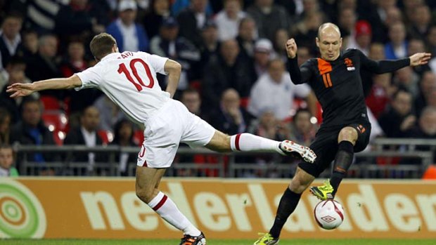 England's Steven Gerrard challenges Holland's Arjen Robben during the friendly.