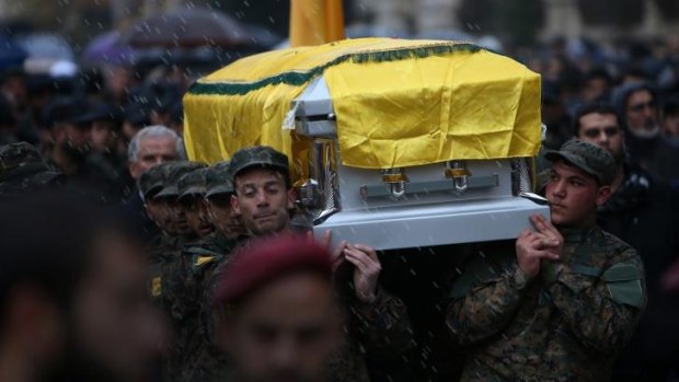 Hezbollah fighters carry the coffin of Hassan al-Laqis, a senior commander killed as he was returning home from work.
